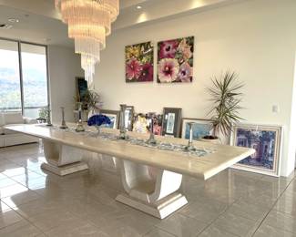 In this different view of the dining table, you can also see the crystal chandelier, and the potted plant (in the background). On the table are a number of candlestick holders and related decorations. We'll come back to the framed artwork....