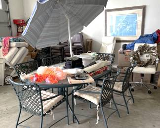 Currently in the garage is a Brown Jordan, glass-topped, oval patio table with matching six chairs, and an umbrella.