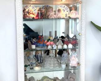 This distressed-finish lighted display cabinet could hold something other than the multitude of dolls...it depends on your collection habits, of course.