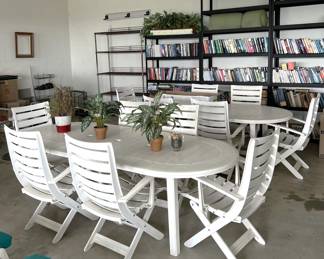 Two oval tables and twelve chairs (six on each table) are poised for the sale.