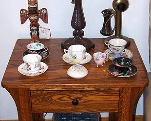 Lamp table, candlestick phone, cups and saucers, Alaska Black Diamond totem, etc...
