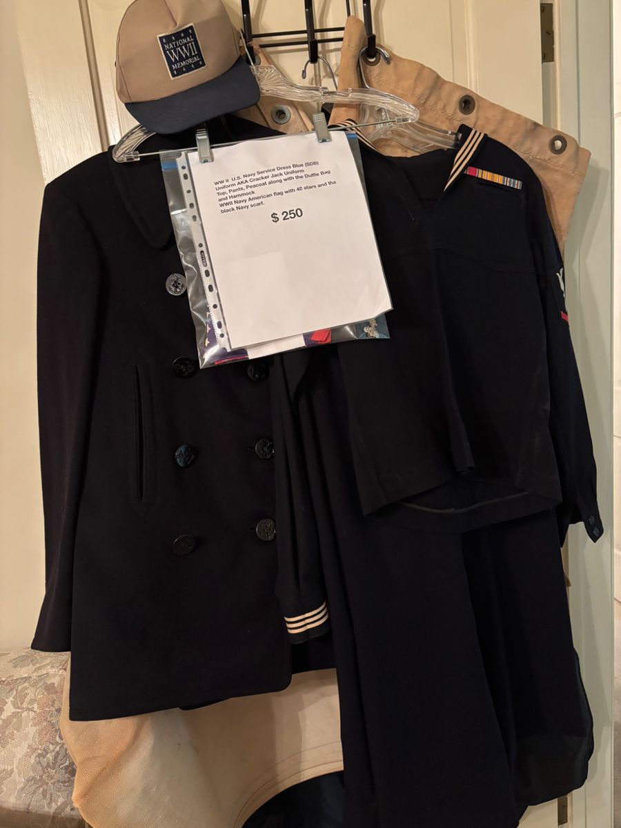 WW II U.S. Navy Service Dress Blue (SDB) Uniform AKA Cracker Jack Uniform, Peacoat along with duffle bag and hammock.  WW II American flag with 48 stars and black Navy scarf