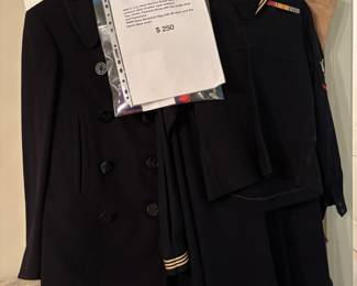 WW II U.S. Navy Service Dress Blue (SDB) Uniform AKA Cracker Jack Uniform, Peacoat along with duffle bag and hammock.  WW II American flag with 48 stars and black Navy scarf