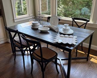 Fabulous custom made dining table from shipping container with Ballard Designs four woven seat chairs