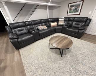 $1,100 (picture 1 of 2) Black Leather (faux) sectional recliner.  3 seats recline. USB ports on outer seats.  4 cupholders and 2 lift-top storage areas. Metal base coffee table included.