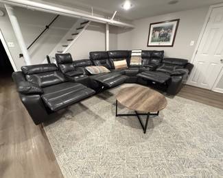 $1,100 (picture 2 of 2) Black Leather (faux) sectional recliner.  3 seats recline. USB ports on outer seats.  4 cupholders and 2 lift-top storage areas. Metal base coffee table included.
