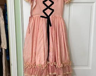 This beautiful dress was worn by Ms. Maglioli when she was an early teen. The dress and hat were handmade and she looked stunning in it. We saw a picture!
