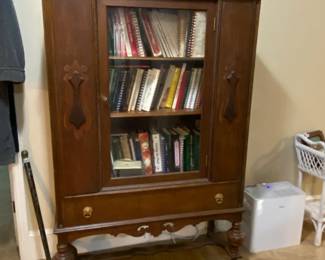 This beautiful cabinet is filled with vintage cookbooks.
