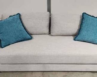 Light Gray Sofa With Turquoise Pillows.