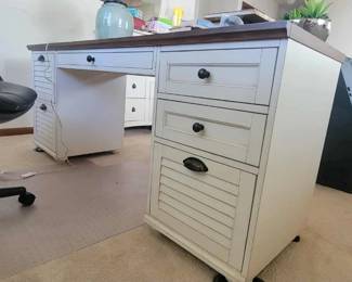 oversized cream-painted desk with louvered drawers and hanging file folder drawers