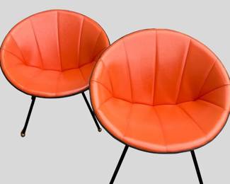 Pair of orange leather barrel shaped saucer chairs