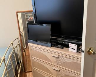 dresser with mirror, and a couple tvs, and a floor mirror