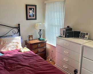 night stand, vase, dressers and a discovery channel dvd player with 2 speakers and a base. 