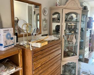 dresser and another curio cabinet filled with beautiful treasures.