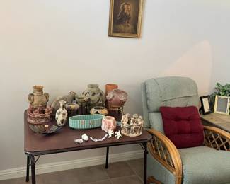 Photo of Christ, and southwestern decor items along with little rabbits and little angels that hang on the side of a plant or other items