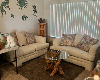 2 twin  couches (match) a rug, table, wall decor, wooden storage cabinet and grapevine table