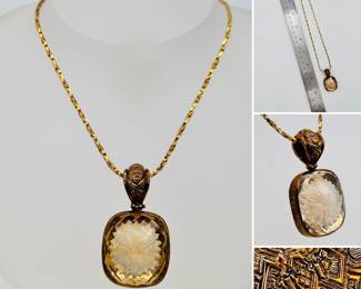 A stylish Stephen Dweck gold tone silver pendant necklace with a translucent gold faceted carved floral motif