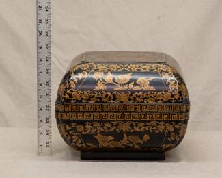 A fine Chinese export black lacquer carved box with gilt painted detailing of peony scrolls and a central panel of flying phoenix birds; the interior of the box painted oxblood red  