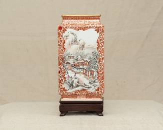 Another view of the Chinese rectangular vase dating from the 1950s with wooden stand. Vase features a coral red lotus and flower tracery ground and 2 famille rose enameled landscape scenes on the front and back. The bottom of the vase has a 4-character mark.