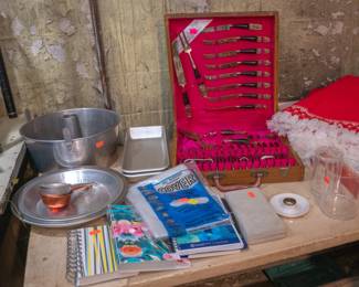 Silverware set in fitted wooden storage case, bundt pan, pie pans, ice cube trays, kitchen storage containers