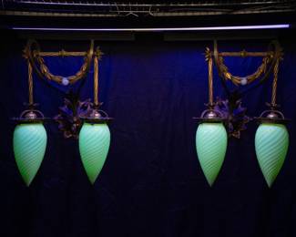 Seen under blacklight: A pair of gorgeous antique sconces with four matching antique hand blown teardrop shape opalescent swirl Vaseline glass (that is also uranium glass) shades