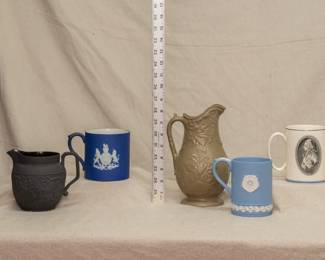 Another view of the vintage Wedgwood pitchers and mugs including a drabware pitcher, a jasper dip mug commemorating King Edward VIII coronation, a Wedgwood "Battle of Trafalgar" Lord Nelson tankard mug, and a Wedgwood black basalt 'Four Home Nations' creamer embossed the four home nations Wales (harp), Ireland (shamrock), England (rose) and Scotland (thistle) and arabesque relief