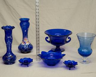 Tiffin Glass cobalt blue console bowl with scrolled handles, a pair of 1930's Fenton cobalt blue glass lotus/flower form 3-toed candlestick holders with matching pattern cobalt blue glass bowl, a Rogaska crystal Windsor Blue flower vase, and two antique Victorian era Bohemiam glass cobalt blue vases with hand painted floral decoration in enamel and gilt