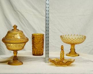 EAPG galore including a Bryce Bros amber glass covered candy dish, Wildflower pattern by Adams; an amber glass celery vase or spooner, and a diamond pattern sawtooth edged amber glass compote