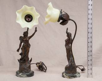 A graceful pair of antique French Art Nouveau era bronzed spelter figural lamps on marble bases, the sculpted female figure of Victory in flowing robes, with the lamp a rising stem supporting a hand-blown uranium glass flower form shade.  The word "Victoire" is modeled on the front base of the figures, and both have the signature of artist Rucho Pse along with a stamp mark reading Paris Made in France.