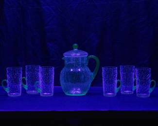 Seen under black light: Antique lemonade set with an uranium crackle glass lidded pitcher and 6 glasses with applied blue glass handles