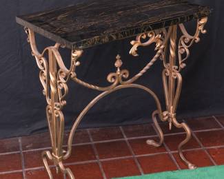A marble topped wrought iron side table