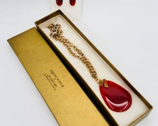 A beautiful polished carnelian pendant necklace with gold tone chain from the Lizzadro Museum of Lapidary Art, and a pair of gold plated sterling silver earrings with polished carnelian tear drop dangles 