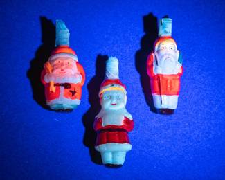 Seen under black light: Three vintage 1940s Santa Claus Christmas light bulbs, hand painted milk glass, double sided figures