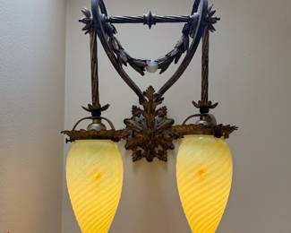 Closeup of the pair of gorgeous antique sconces with four matching antique hand blown teardrop shape opalescent swirl Vaseline glass (that is also uranium glass) shades