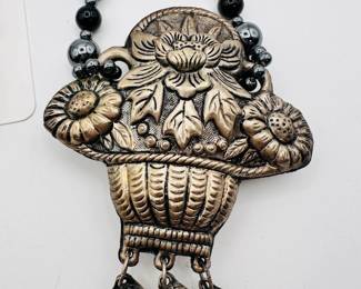 Closeup view of the beaded necklace with silver metal Tibetan style flower basket pendant