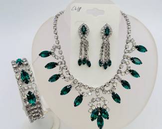 A glamorous vintage emerald green and clear rhinestone parure of necklace, bracelet and dangling clip earrings set with sparkling clear and marquise shaped green rhinestones. Retro Hollywood red carpet show stoppers!