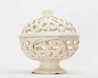 Another view of the late 19th century antique Wedgwood cream ware footed “orange bowl” and cover, beautifully crafted with symmetrical pierced lattice work, garland and foliate scrolls with applied twisted rope handles and a flower finial. 10” high x 9” wide. Impressed Wedgwood stamp beneath the circular foot. 