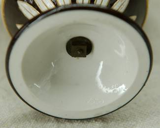Closeup of the antique 1850's Wedgwood black dip jasper ware double handled urn shaped vase with applied classical figures in white relief depicting the muses of comedy/drama, music, poetry; covered overall in a shiny clear glaze and with applied gilding. Wedgwood stamp to the base along with group of 4 "mustache" marks, and hand-incised numerals 350. See example in of this vase in the Nelson Provincial Museum, Australia.