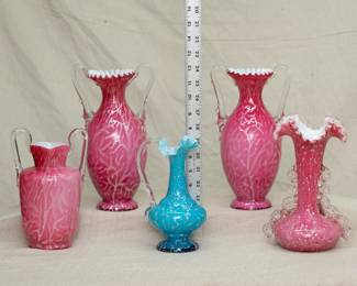 A selection of antique art glass vases, cased glass white with pink or blue and silver mica patterns, clear glass applied "thorn" handles, crimped/ruffled rims
