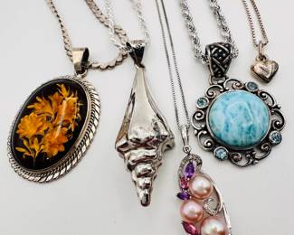 Closeup of some of the pendant necklaces available, from silvery shells to polished natural stone cabochons, rhinestones and pearls