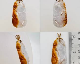 A carved russet jade pendant with gold bail