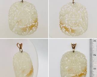 A carved Chinese jade pendant with unmarked gold bail, the jade carved and pierced with a central Chinese character surrounded by auspicious objects