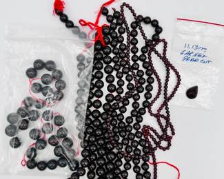 Strings of glowing deep red polished garnet beads
