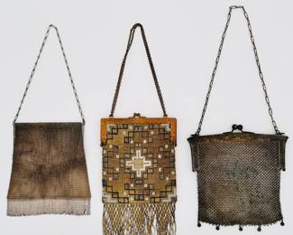 Another view of the antique Whiting & Davis metal mesh chainmail Princess Mary design purse/handbag with metal chain handle, an antique French Art Deco metal mesh beaded fringed handbag with gold and black geometric pattern and metal beaded fringe, and a 1920s metal mesh handbag with chain handle, the frame stamped German Silver