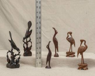Beautifully carved wooden figures of cranes, and a pair of Indonesian carved wooden birds perched on branch above feeding their baby chicks - the later sculptures likely from the Njana Tilem Museum in Bali