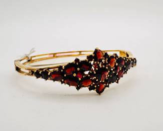 Another view of the lovely vintage gold tone bracelet set with faceted richly colored garnets, with a safety chain; clasp stamped "German"
