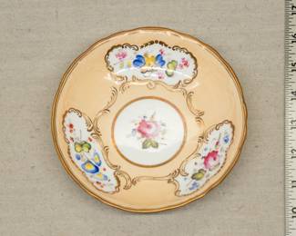 An early 19th century Rockingham porcelain dish hand painted with panels of floral sprays with moulded scrolls heightened with gilding