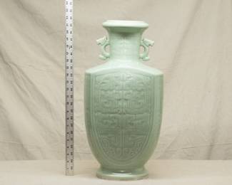 A massive vintage Chinese porcelain celadon glaze vase, carved pattern of archaistic dragons and with mythical animal double handles at the neck 