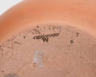 Closeup of the large mid-19th century Wedgwood Rosso Antico bottle vase, a graceful classic form unadorned but for two raised horizontal rings around the lower neck. Unglazed and showing the fine grain of the material. 11” H. 