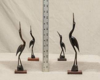 Carved wooden statues of cranes